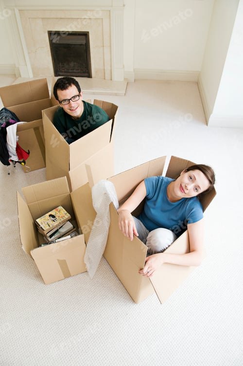 Preview: A couple sitting in cardboard boxes