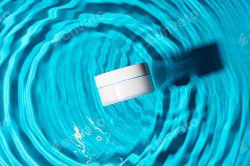 Preview: Sunscreen bottle floating in a clear blue swimming pool on a sunny day