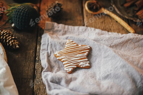 Preview: Christmas star decorated gingerbread cookie on rustic table.Making christmas cookies. Happy Holidays
