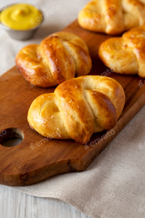 Preview: Homemade Basic Soft Pretzels with Mustard, low angle view. Close-up.