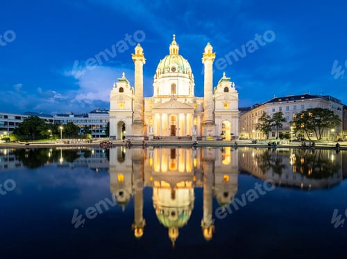 Preview: Beautiful shot of St. Charles Church illuminated at night, reflecting in a pond in Vienna, Austria