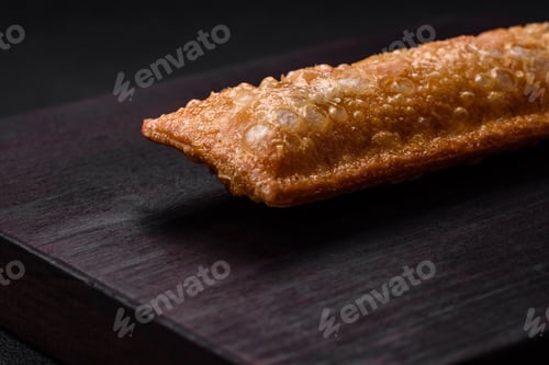 Preview: Delicious fresh crispy pie with cherry jam on a wooden cutting board