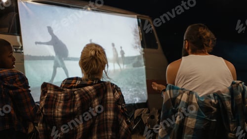 Preview: Group Of Friends Having Fun And Relaxing While Watching Movie On Screen On Van In Night Time