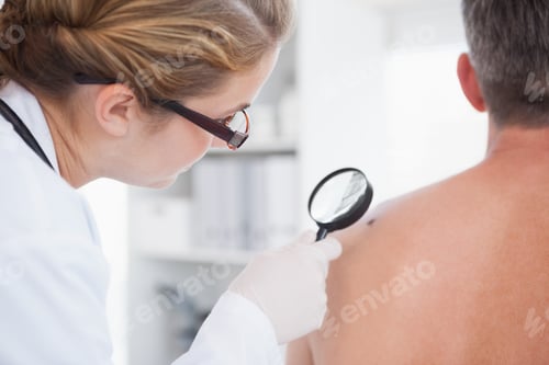 Preview: Doctor examining a brown spot on a patients shoulder