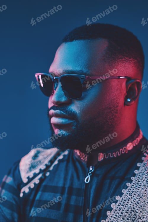 Preview: Well dressed black man posing against dark background
