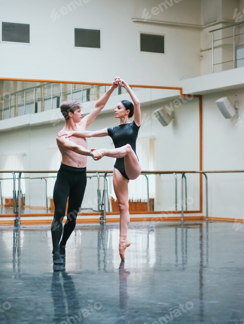 Preview: Man practicing in ballet with partner ballerina woman in black clothing in gym