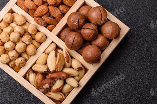 Preview: Wooden box with macadamia nuts, almonds, pistachios, and hazelnuts. Nuts as a food background