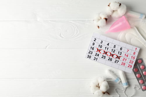 Preview: Menstruation period accessories on wooden background, space for text