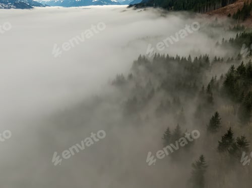 Preview: Aerial View of Canadian Mountain Landscape covered in fog over Harrison Lake