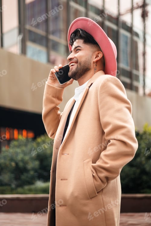 Preview: young colombian man using smartphone, closeup side portrait