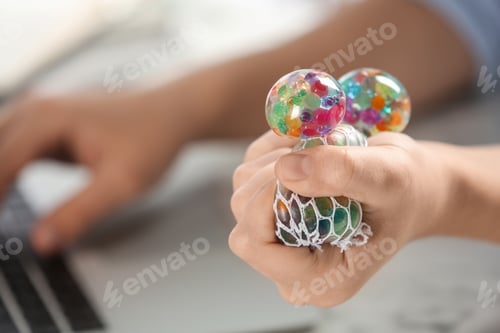 Preview: Woman squeezing colorful slime, closeup. Antistress toy