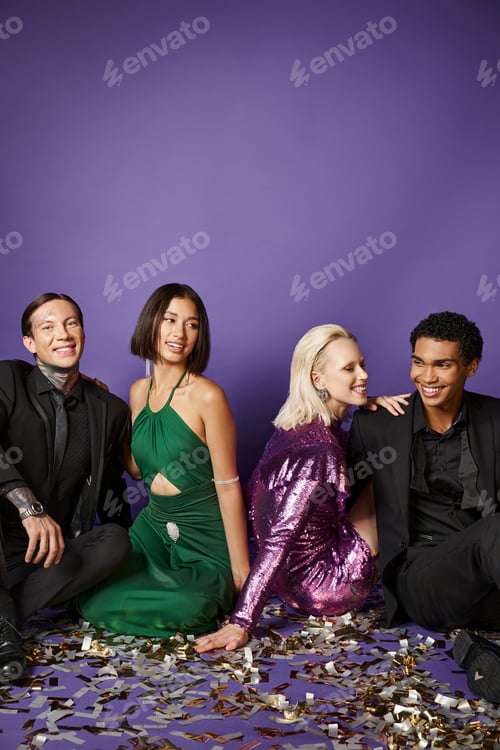 Preview: New Year 2024, happy multiethnic friends in party clothes sitting on festive confetti on purple