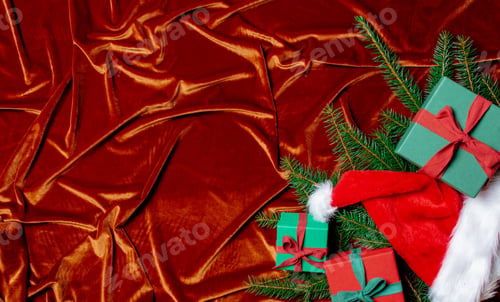 Preview: Christmas gift boxes and spruce branch on Crimson Red fabric background