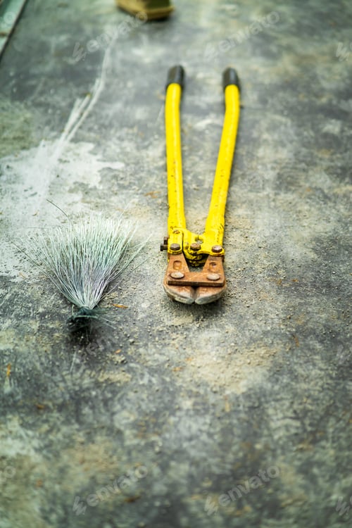 Preview: top view of yellow wrench on the concrete floor
