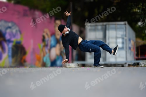 Vista previa: Energetic Asian male dancer stylish clothes dancing hip hop on the street
