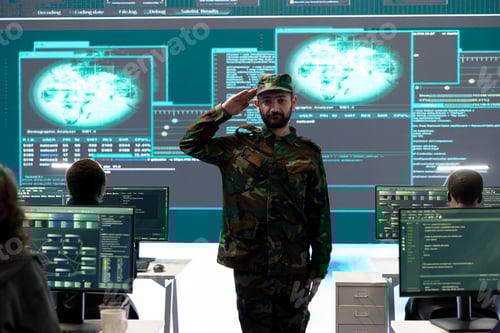 Preview: Man in Camouflage Saluting in a Technology Workplace
