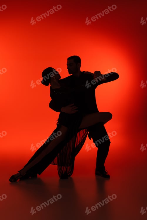Preview: Silhouette of couple dancing tango on red background