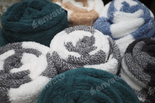 Preview: A vibrant display of rolled towels featuring a variety of textures and unique designs
