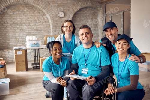 Preview: Portrait of happy diverse volunteers working at community center and looking at camera.