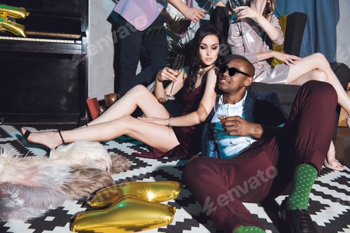 Preview: happy young beautiful couple on party drinking champagne