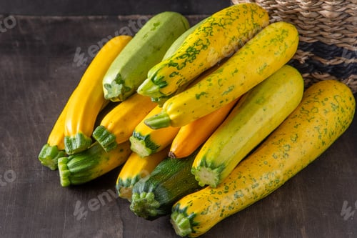 Preview: Yellow-green leopard-spotted zucchini. Vegetables on the table. Zucchini harvest.