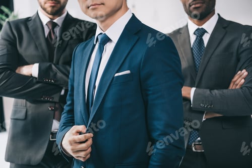Preview: cropped shot of group of multiethic businessmen