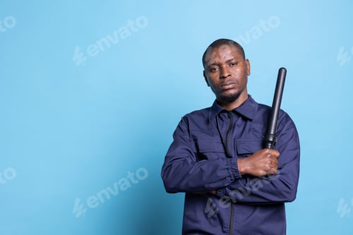 Preview: African american security guard feels proud with his baton in studio