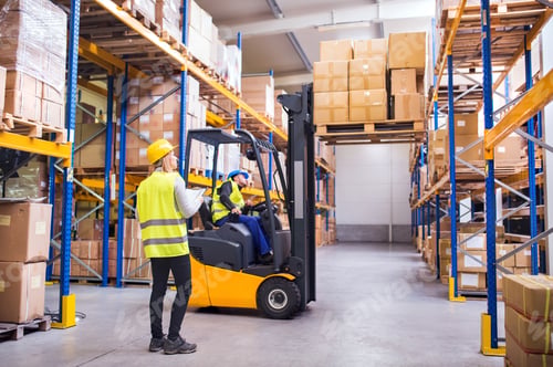 Preview: Young warehouse workers working together.