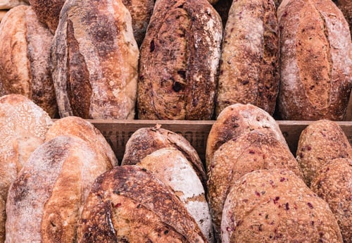 Preview: Closeup of fresh loaves of bread on the racks of a market