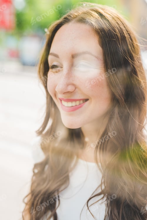 Preview: Portrait of a young beautiful millennial green eyes woman overlooking view behind window