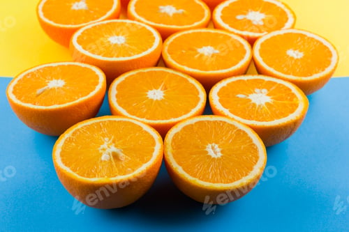 Preview: Cut Halves Of Juicy Orange On Yellow Blue Background. Orange Fruit, Citrus Minimal Concept