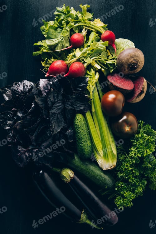 Preview: top view of radishes, eggplants and tomatoes on grey dark table