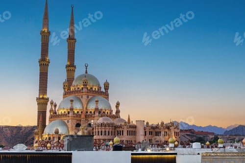 Preview: Majestic mosque with tall minarets at dusk in a serene desert landscape