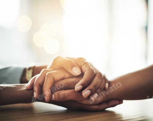 Preview: I just want to help you. Closeup shot of two women holding hands.