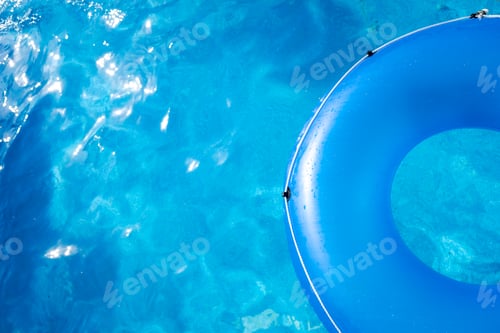 Preview: A large blue round float on a pool of transparent water, copy space.