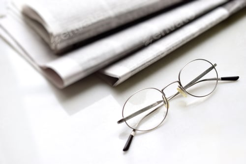 Preview: Reading glasses and newspapers on the table