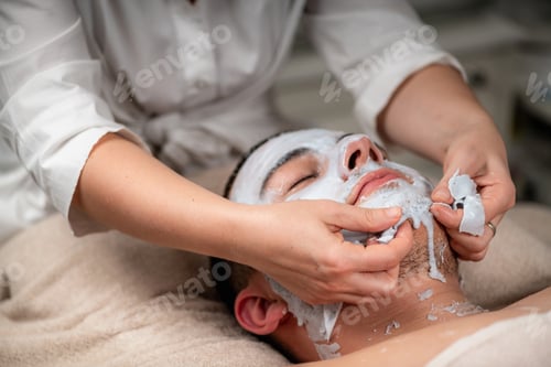 Preview: Man enjoying a plant based facial mask treatment at a beauty cen