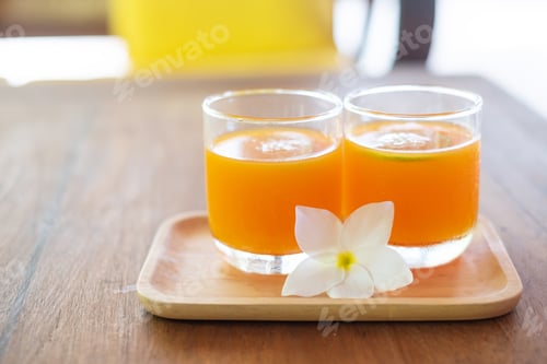 Preview: Refreshing Orange Juice in Glasses with Flower