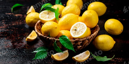 Preview: Basket with ripe lemons and leaves.