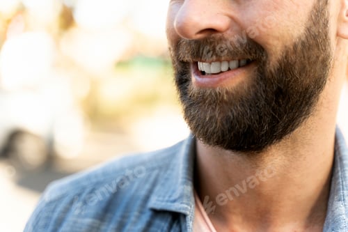 Preview: Smiling bearded customer after barber shop service, selective focus