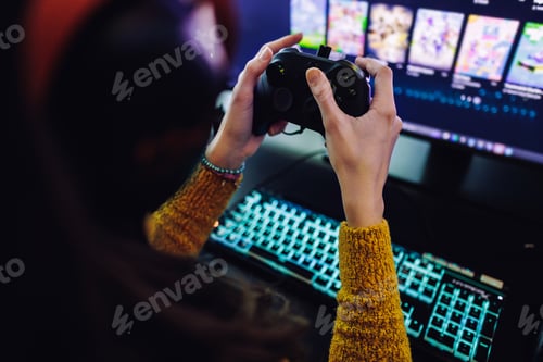 Preview: Gamer girl playing online video games holding controller in living room