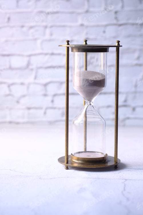 Preview: hourglass on table, sand flowing through the bulb of sandglass