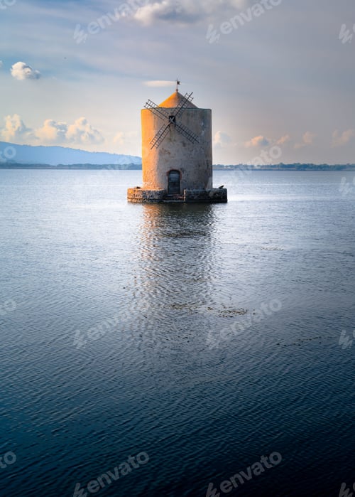Preview: Ancient Spanish Mill in Italy at sunset surrounded by the sea