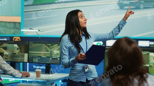 Preview: Indian supervisor assigning tasks for her operators team in observation room
