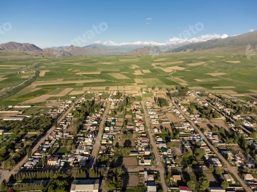 Preview: Aerial view of the village of Toguz Bulak, surrounded by farms in Kyrgyzstan.