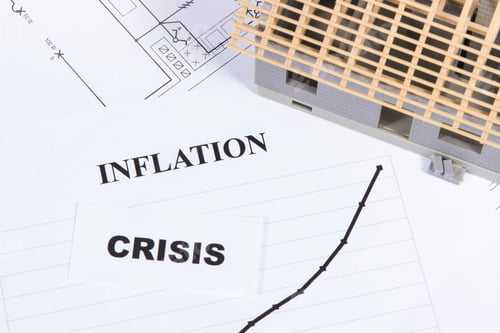 Preview: Inscriptions inflation and crisis, toy house under construction and construction drawings