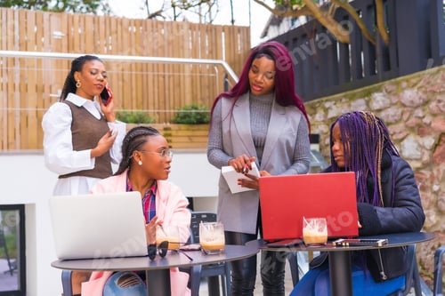 Preview: Young businesswomen of black ethnicity. In a business meeting in a cafeteria