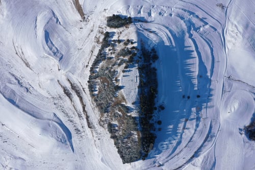 Preview: Aerial Drone View of Snow Covered Countryside Hills with Light Snow