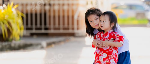 Preview: Portrait of Asian sibling embracing each other, in the evening after school.