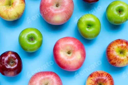 Preview: Variety of fresh apples on blue background.